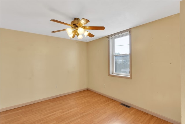 empty room with light wood-type flooring and ceiling fan