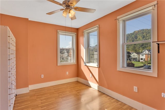 unfurnished room with ceiling fan and light hardwood / wood-style flooring