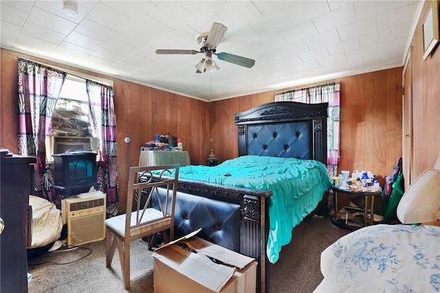 bedroom featuring wood walls, carpet flooring, ceiling fan, and cooling unit