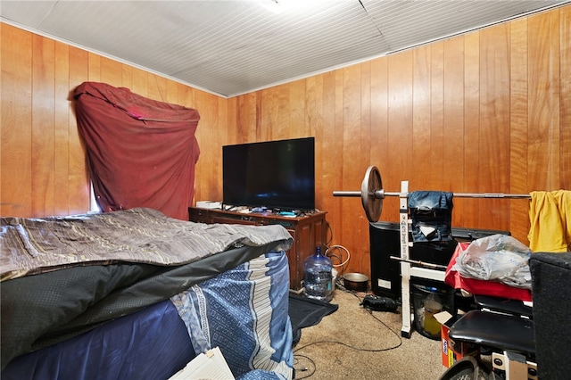 carpeted bedroom featuring wooden walls