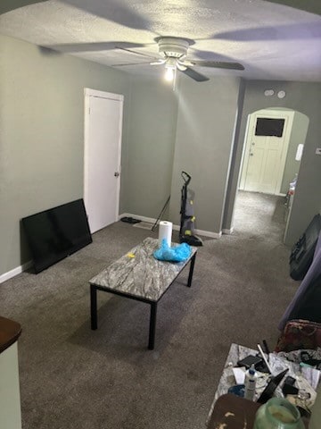 carpeted living room featuring ceiling fan