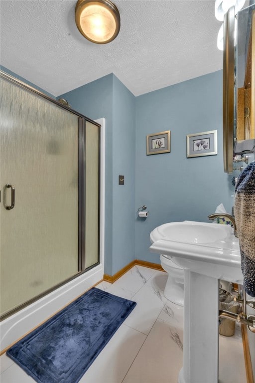 bathroom with walk in shower, tile patterned flooring, toilet, and a textured ceiling