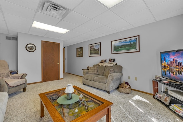 living room featuring a paneled ceiling and carpet