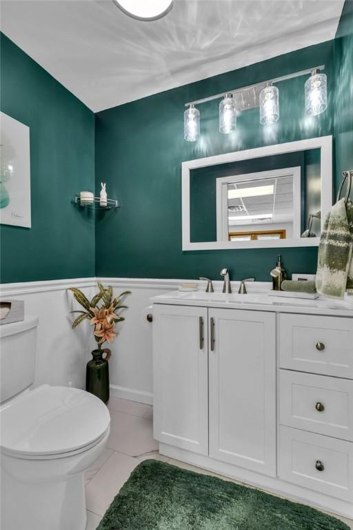 bathroom featuring tile patterned floors, toilet, and vanity