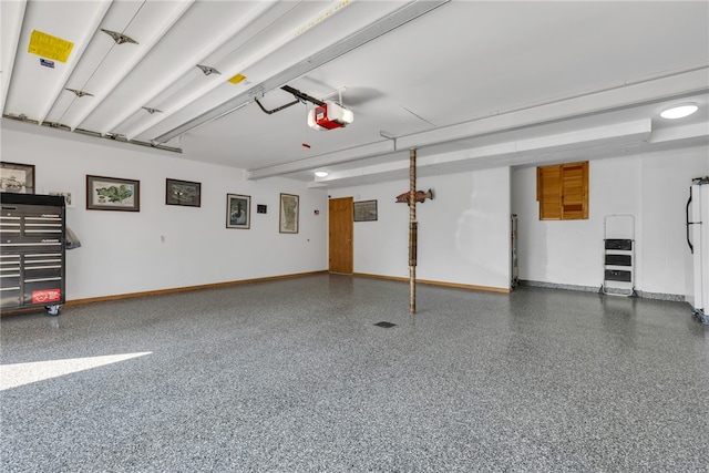 garage featuring white refrigerator and a garage door opener