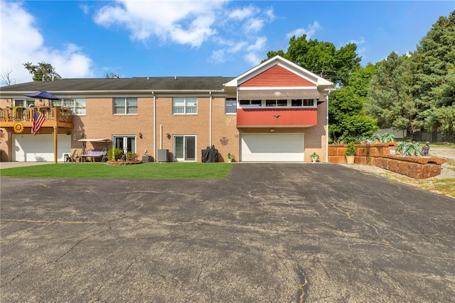 view of front of home with a garage and central AC unit