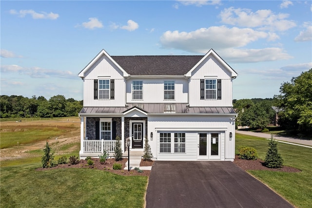 view of front of house with covered porch and a front lawn