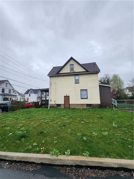 view of side of home featuring a yard