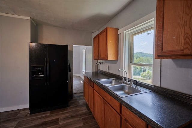 kitchen featuring dark hardwood / wood-style flooring, sink, and black fridge with ice dispenser