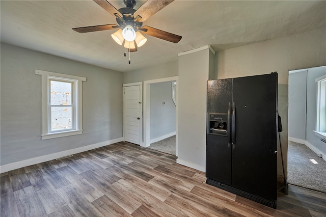 kitchen featuring black refrigerator with ice dispenser, wood-type flooring, and ceiling fan