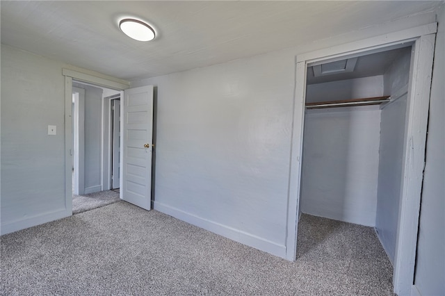 unfurnished bedroom featuring light colored carpet and a closet