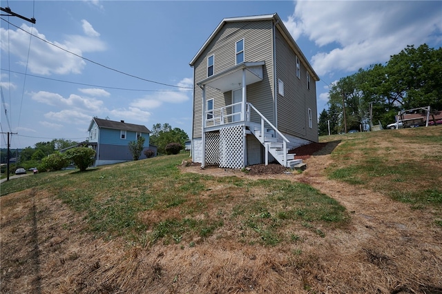 rear view of house featuring a yard