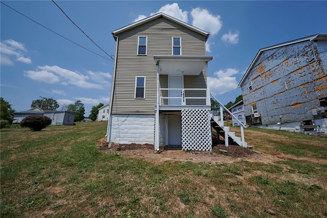 back of property with a lawn