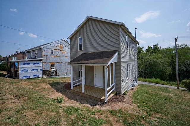 back of house with a yard