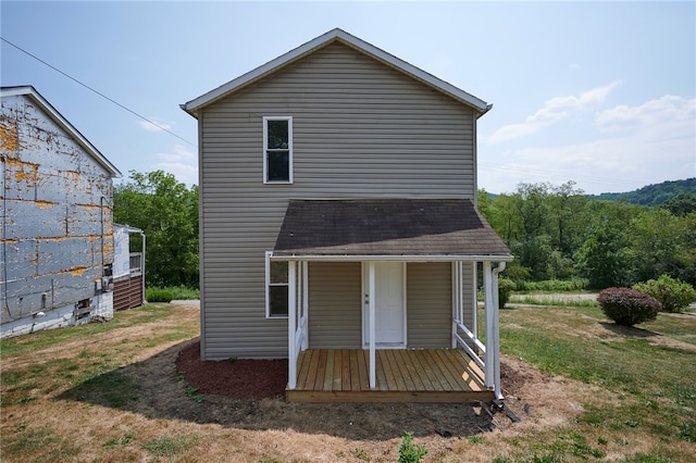 rear view of property with a lawn