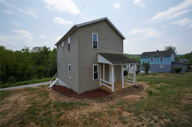 rear view of house with a lawn