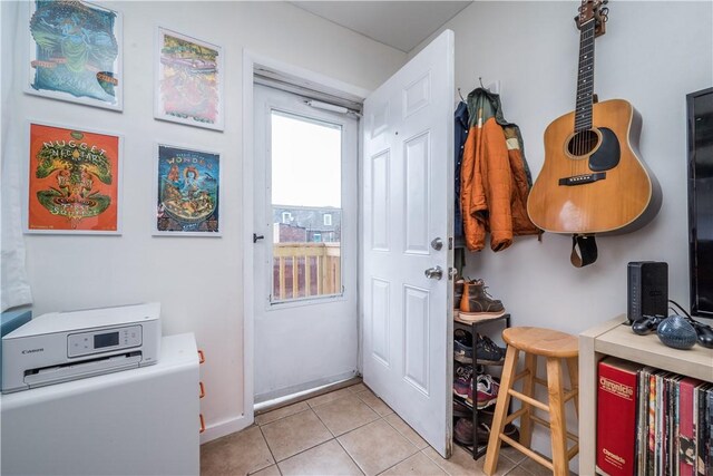 doorway with light tile patterned floors