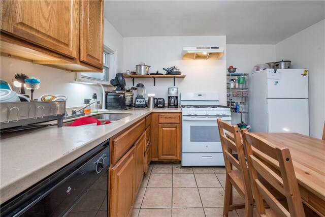 kitchen featuring light tile patterned flooring, white appliances, and sink