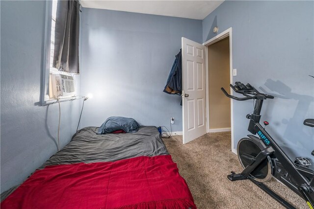 bedroom featuring cooling unit and carpet flooring