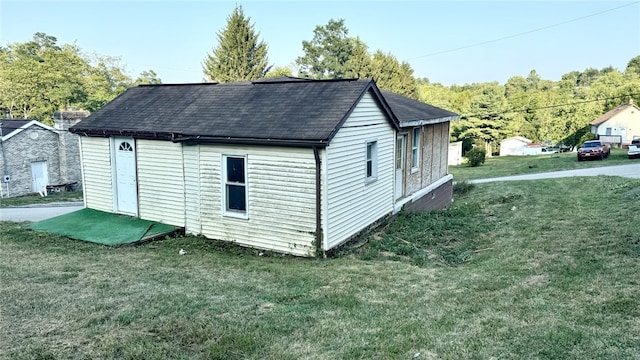 rear view of house featuring a lawn