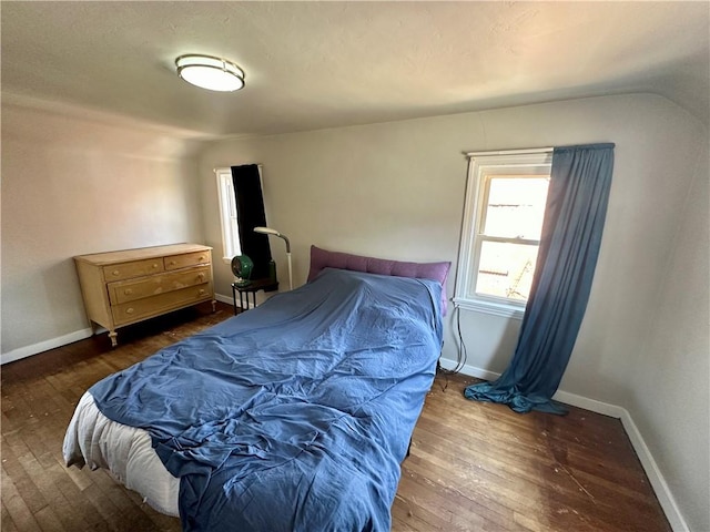 bedroom with dark hardwood / wood-style floors