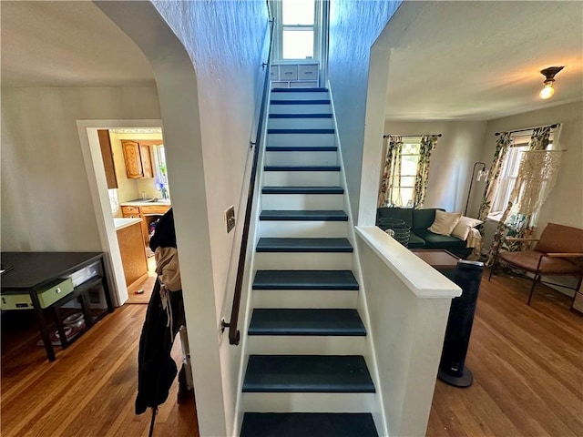 stairs with wood-type flooring