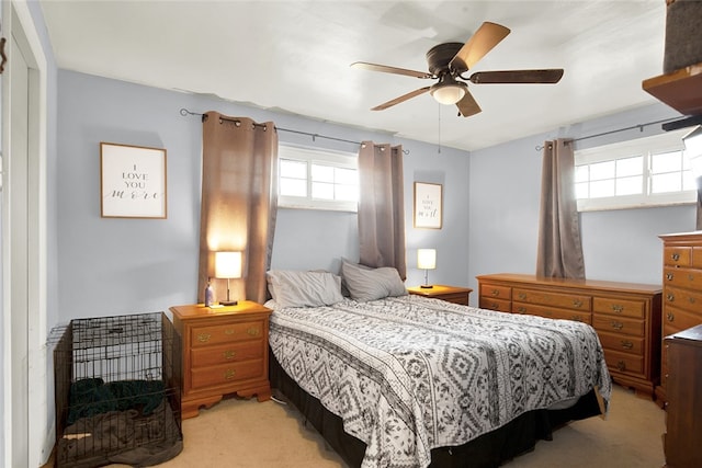 bedroom featuring light carpet and ceiling fan