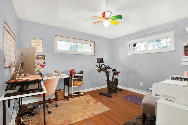 home office featuring wood-type flooring and ceiling fan