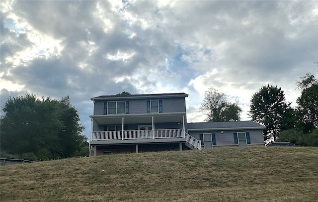 rear view of property featuring a yard