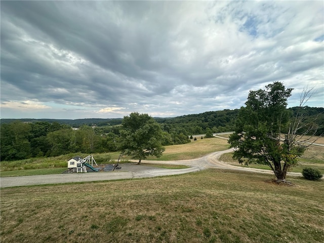 view of home's community with a yard and a playground