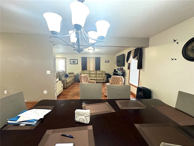 dining space featuring an inviting chandelier and hardwood / wood-style floors