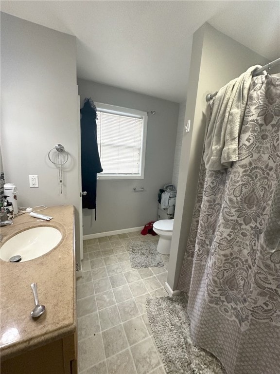 bathroom featuring tile patterned floors, vanity, and toilet