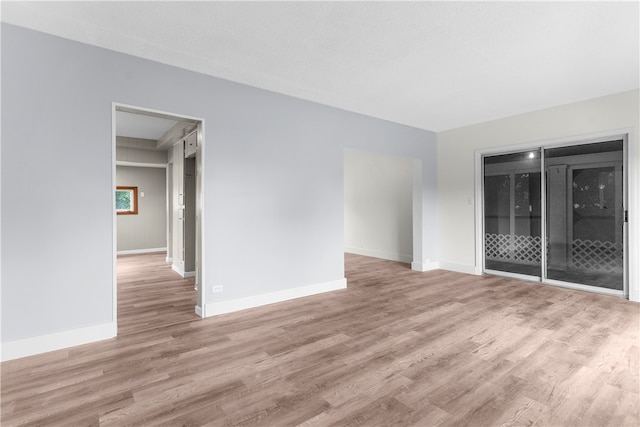 empty room with hardwood / wood-style floors