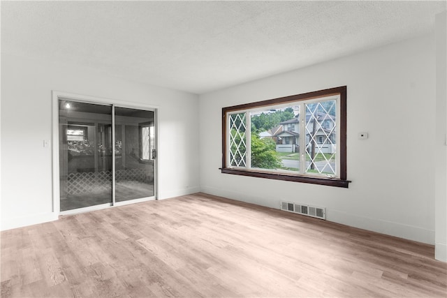 unfurnished bedroom with a closet, a textured ceiling, and hardwood / wood-style flooring