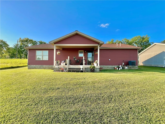 view of front facade with a front lawn and central AC