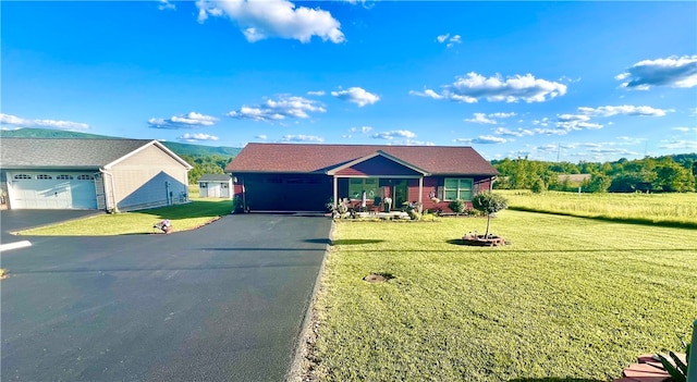 ranch-style home with a garage, a porch, and a front yard