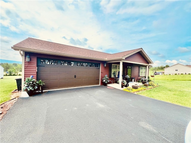 view of front of home with a garage and a front lawn