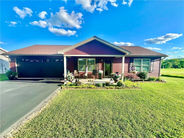 ranch-style home featuring a garage, covered porch, and a front lawn