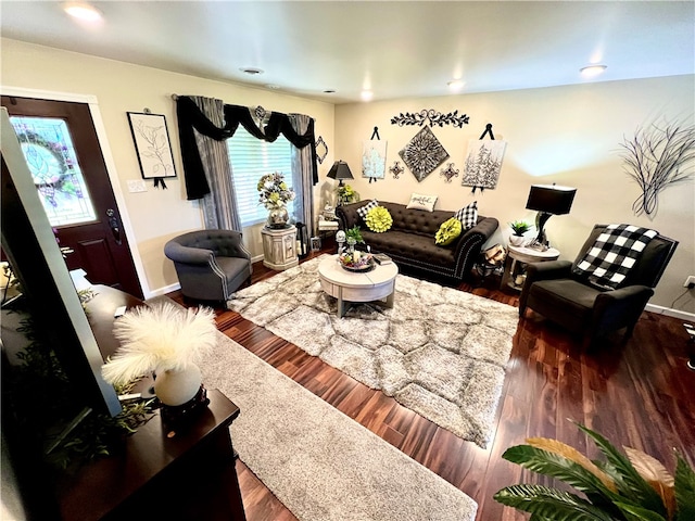 living room with a healthy amount of sunlight and dark hardwood / wood-style flooring