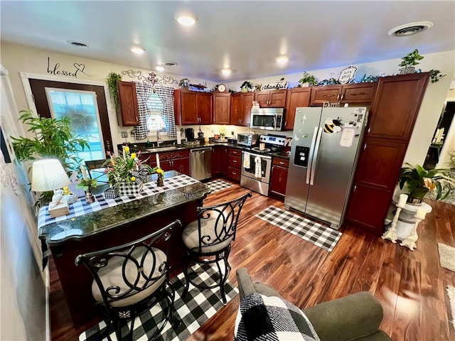 kitchen with dark wood-type flooring, sink, and appliances with stainless steel finishes