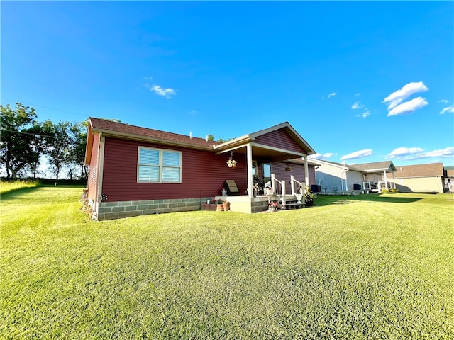 rear view of property with a lawn and a patio area