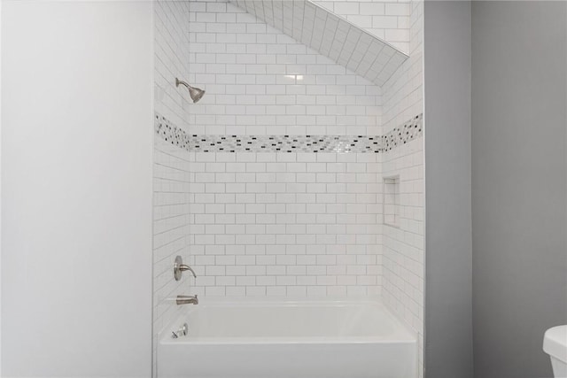 bathroom featuring toilet and shower / bathtub combination