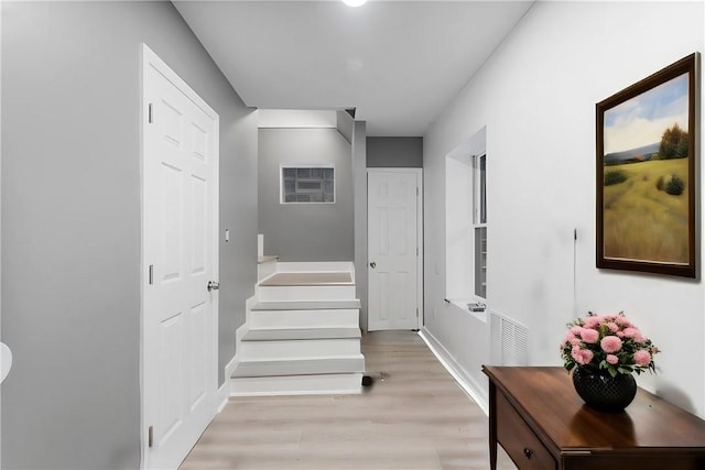 stairway with baseboards and wood finished floors