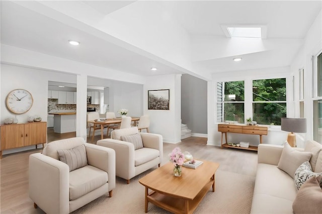 living area with light wood-style flooring, stairs, and recessed lighting