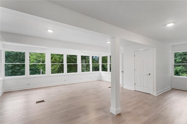 spare room with light wood-style floors, recessed lighting, visible vents, and baseboards