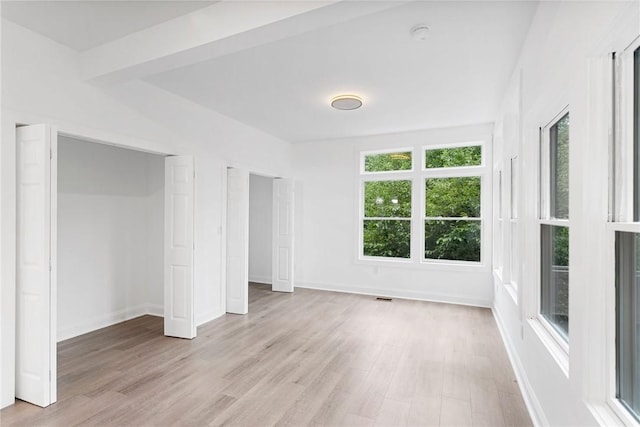 unfurnished bedroom with light wood-type flooring, baseboards, and visible vents