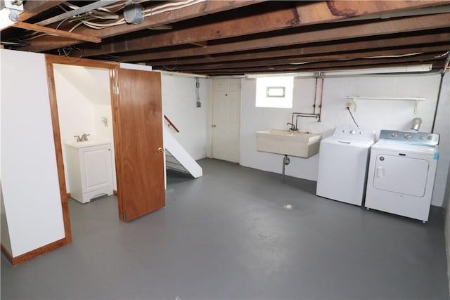 below grade area featuring washing machine and dryer and a sink