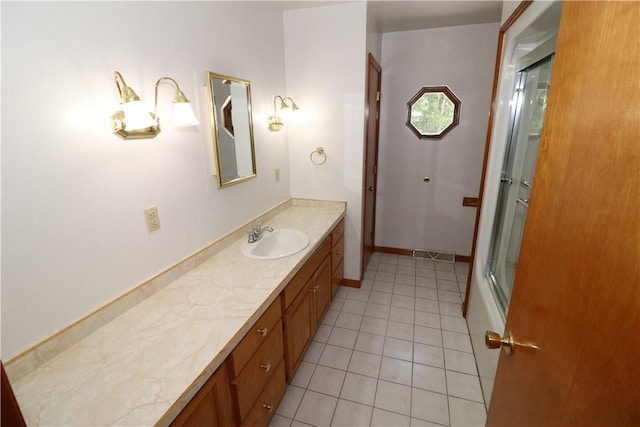 bathroom with visible vents, vanity, baseboards, and tile patterned floors