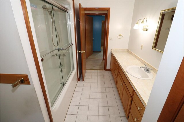 bathroom featuring tile patterned flooring, vanity, and an enclosed shower