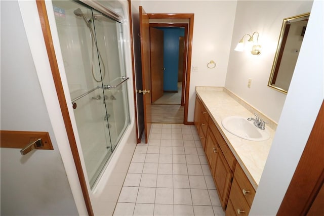 bathroom featuring tile patterned flooring, an enclosed shower, and vanity